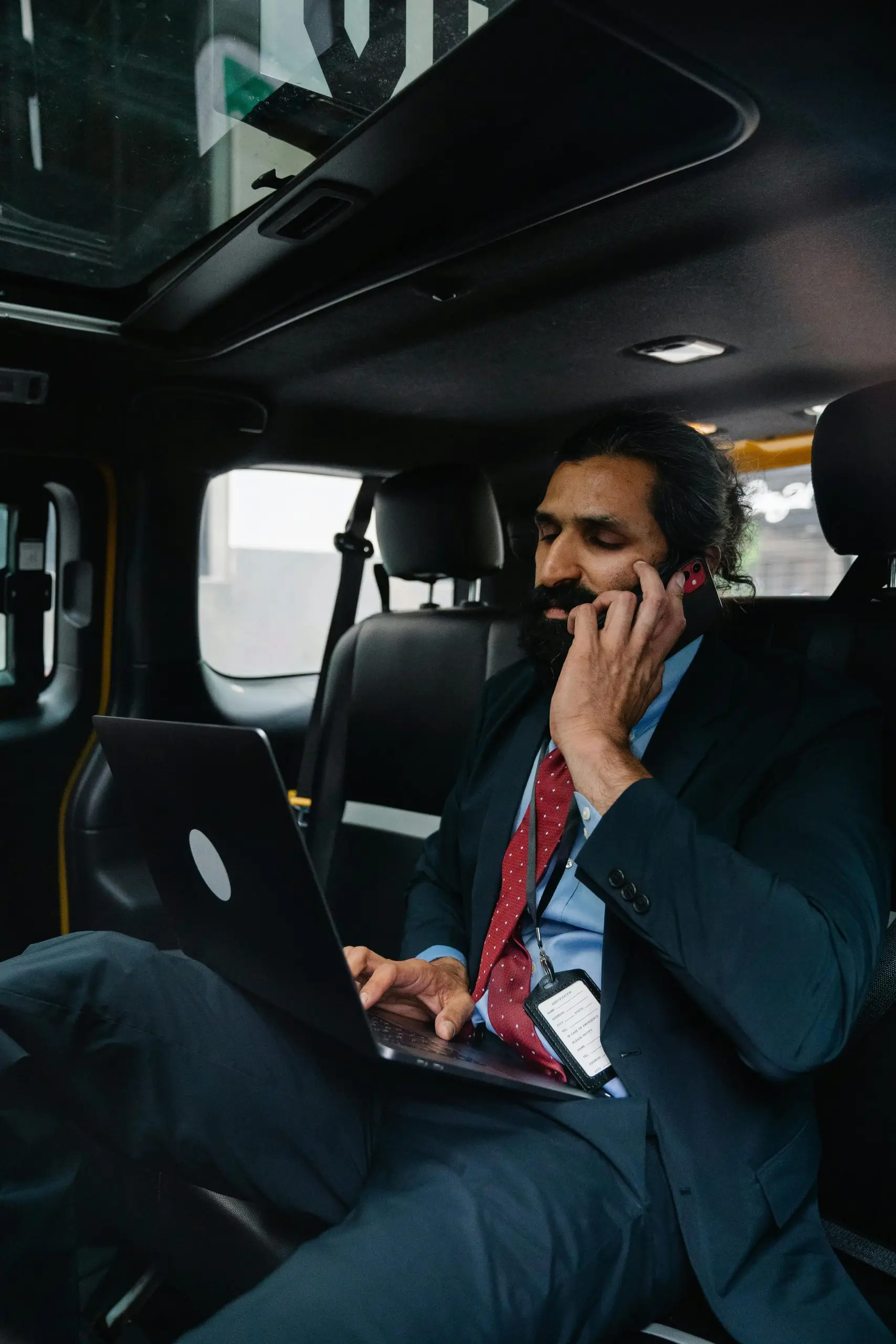 Executive working on a laptop during a ride