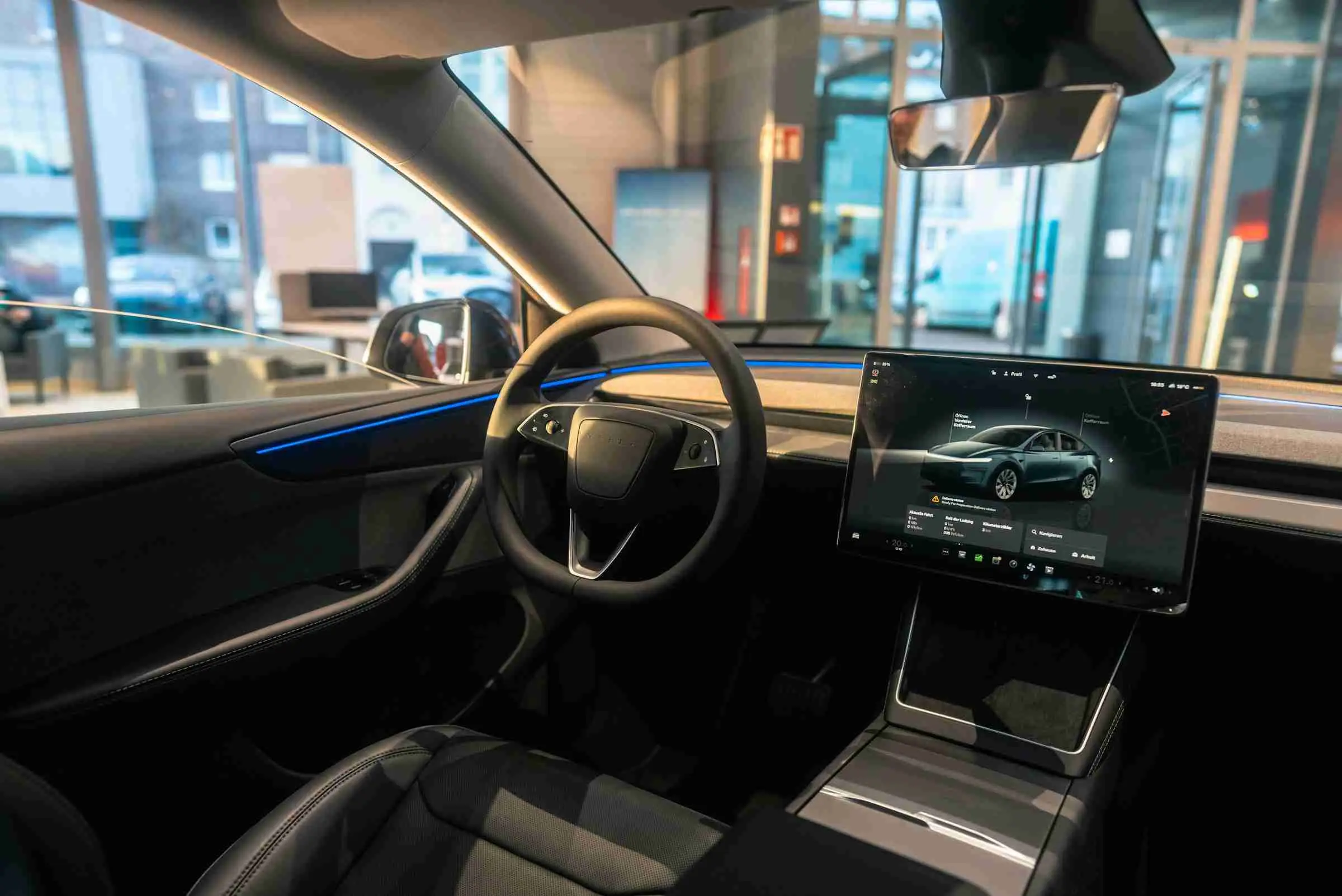 Interior of a Tesla Model Y taxi with panoramic glass roof